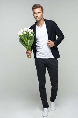 Handsome man with flowersの写真素材