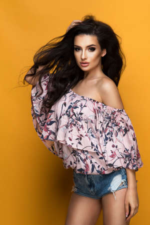 Beauty fashion woman in pastel dress with flowers in hairの写真素材