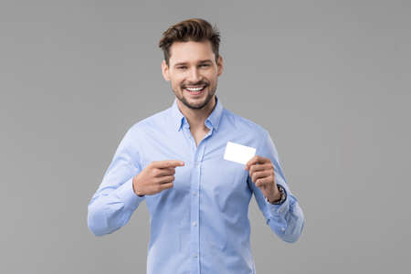 Handsome man in blue shirt  with white cardの写真素材