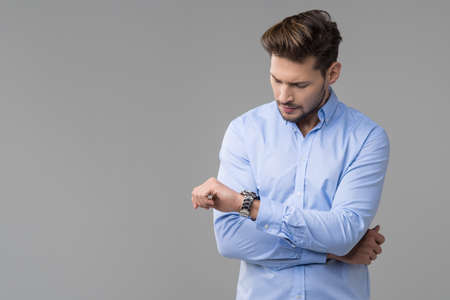 Happy handsome man with watchの写真素材