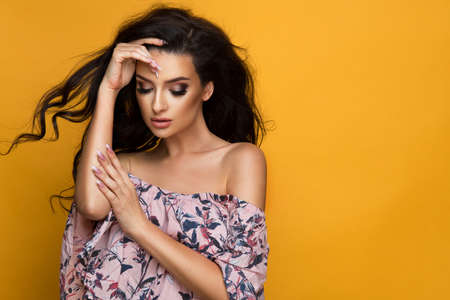 Beauty fashion woman in pastel dress with flowers in hairの写真素材