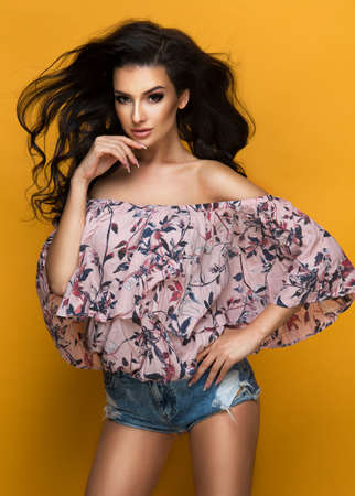 Beauty fashion woman in pastel dress with flowers in hairの写真素材