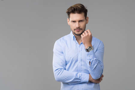 Happy handsome man with watchの写真素材