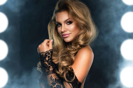 Portrait of beauty blonde woman in dark roomの写真素材