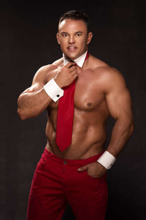 Young elegant handsome athlete with red tieの写真素材