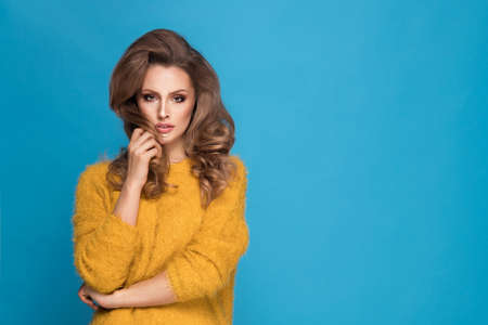 Portrait of a adorable woman over blue backgroundの写真素材