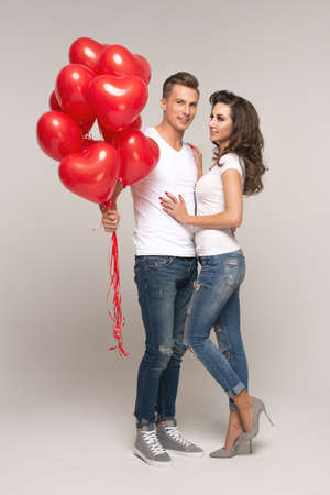 Happy lover couple with red balloon. Valentines Dayの写真素材
