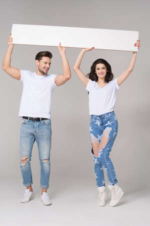 Happy summer couple with white boardの写真素材