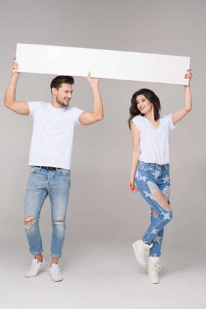 Happy summer couple with white boardの写真素材