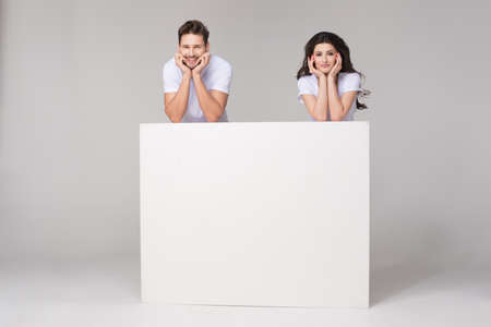 Happy summer couple with white boardの写真素材