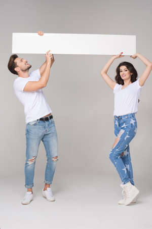 Happy summer couple with white boardの写真素材