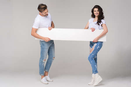 Happy summer couple with white boardの写真素材