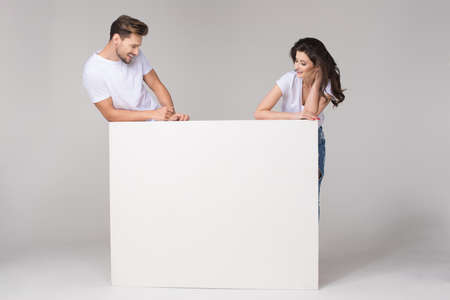 Happy summer couple with white boardの写真素材
