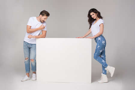 Happy summer couple with white boardの写真素材