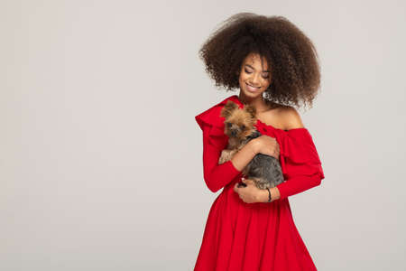 Happy young woman with puppyの写真素材