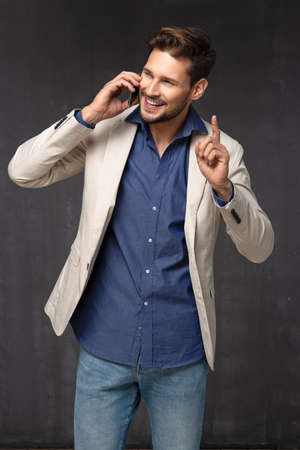 Happy handsome man over with phoneの写真素材