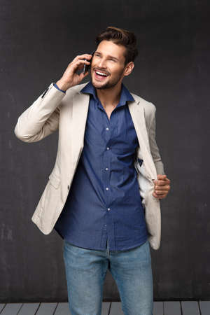 Happy handsome man over with phoneの写真素材