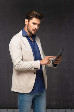 Happy handsome man with tabletの写真素材