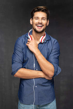 Happy young man with headphones. Listening musicの写真素材