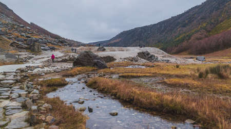 Road in Glendalough, Wicklow, Ireland. Yellow and ornage grass field with mountains on the background. Winter in Wicklow.の写真素材