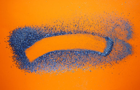 Creative composition of blue glitter sparkle on orange background.