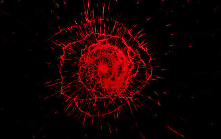 Red crack in broken window on black background. Broken glass texture.の写真素材