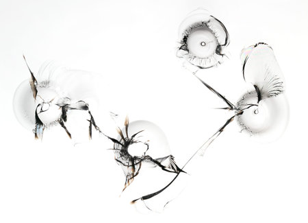 Set of holes in glass. Broken window texture on white background. Macro.