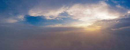 Beautiful sunrise over cloudy sky. View from the drone above the clouds.