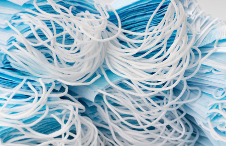 Close-up shot of many medical face masks to prevent the spread of coronavirus infection.