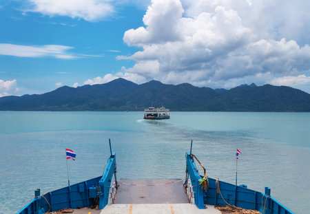 Ferry sailing on the sea to the island with mountains in Thailand.の写真素材