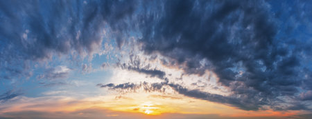 Dramatic sunset sky with clouds. Panorama of the evening sky.