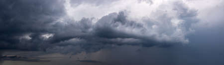 Dramatic sky background with dark rainy clouds before the storm. Panoramic view.の写真素材