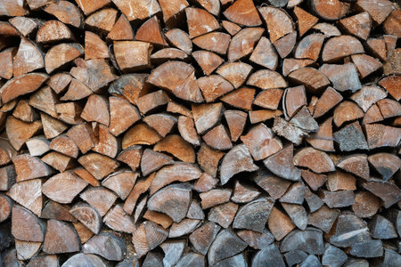 Background of stacked firewood. Wood texture
