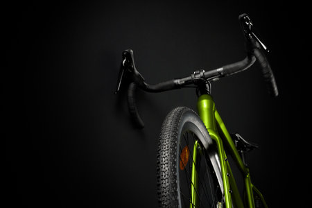 Gravel green bicycle, shot from the bottom of the front wheel. Black background.の写真素材