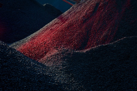 Heaps of coal in the red lightの写真素材