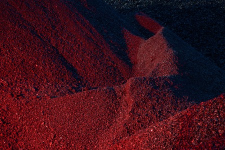 Heaps of coal in the red lightの写真素材
