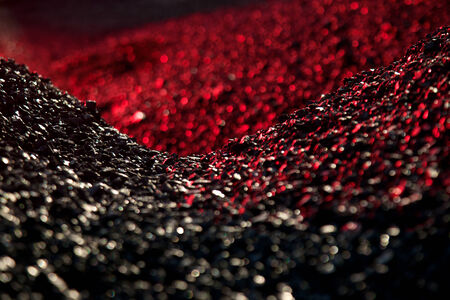 Heaps of coal in the red lightの写真素材