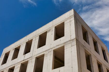 A modern concrete office building under constructionの写真素材