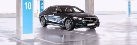Luxurious Mercedes S Class, standing in an empty underground parking lot in the background of...