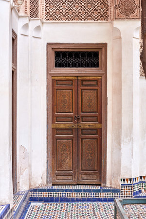 Decorated door in the palace El Bahia Palace. It is visited by tourists from all world. It is an...