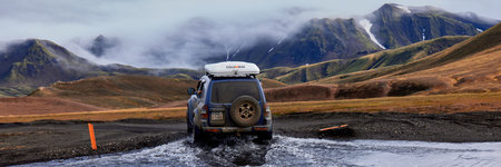 Iceland, Mitsubishi Pajerio crossing the river on the route to the LANDMANNALAUGAR mountains....