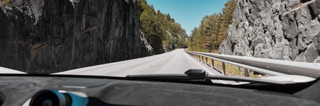 The road between the rocks, seen from inside a fast-moving sports carのeditorial素材