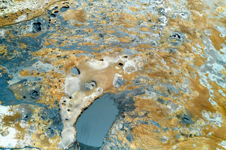 Hverir, Iceland. An expansive geothermal area displays vibrant earth tones and unique formations, showing natural pools and textures.の写真素材