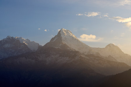 Majestic South Annapurna peak rises against the glowing sky, showcasing the Himalayas' beauty during a serene sunrise at Poon Hill, Nepal.の写真素材