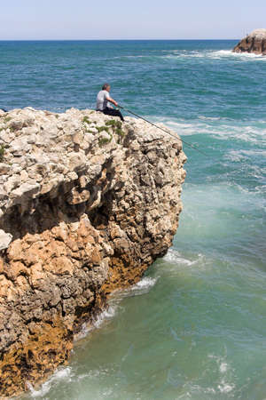 fisherman at the cliff border , Cantabria, Spainの写真素材