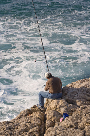 a fisher man and his fishing rodの写真素材