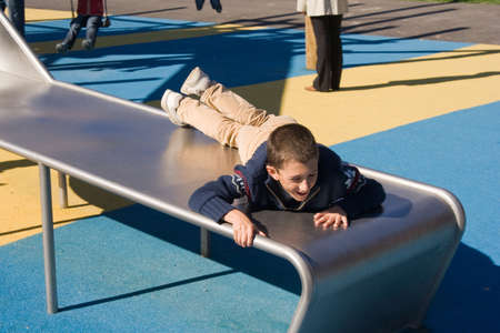 descending a children's slide upside downの写真素材