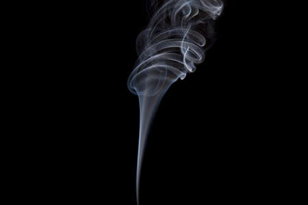 Smoke volutes on a pure black background の写真素材