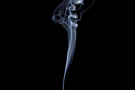 Smoke volutes on a pure black background の写真素材