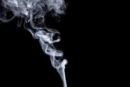 Smoke volutes on a pure black backgroundの写真素材